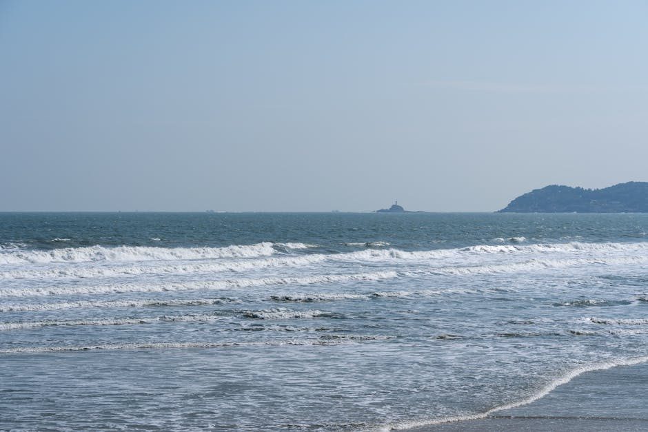 Peaceful ocean scene featuring gentle waves under a clear blue sky, ideal for relaxation concepts.